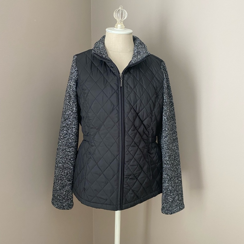 Weatherproof light weight jacket with fleece sleeves.